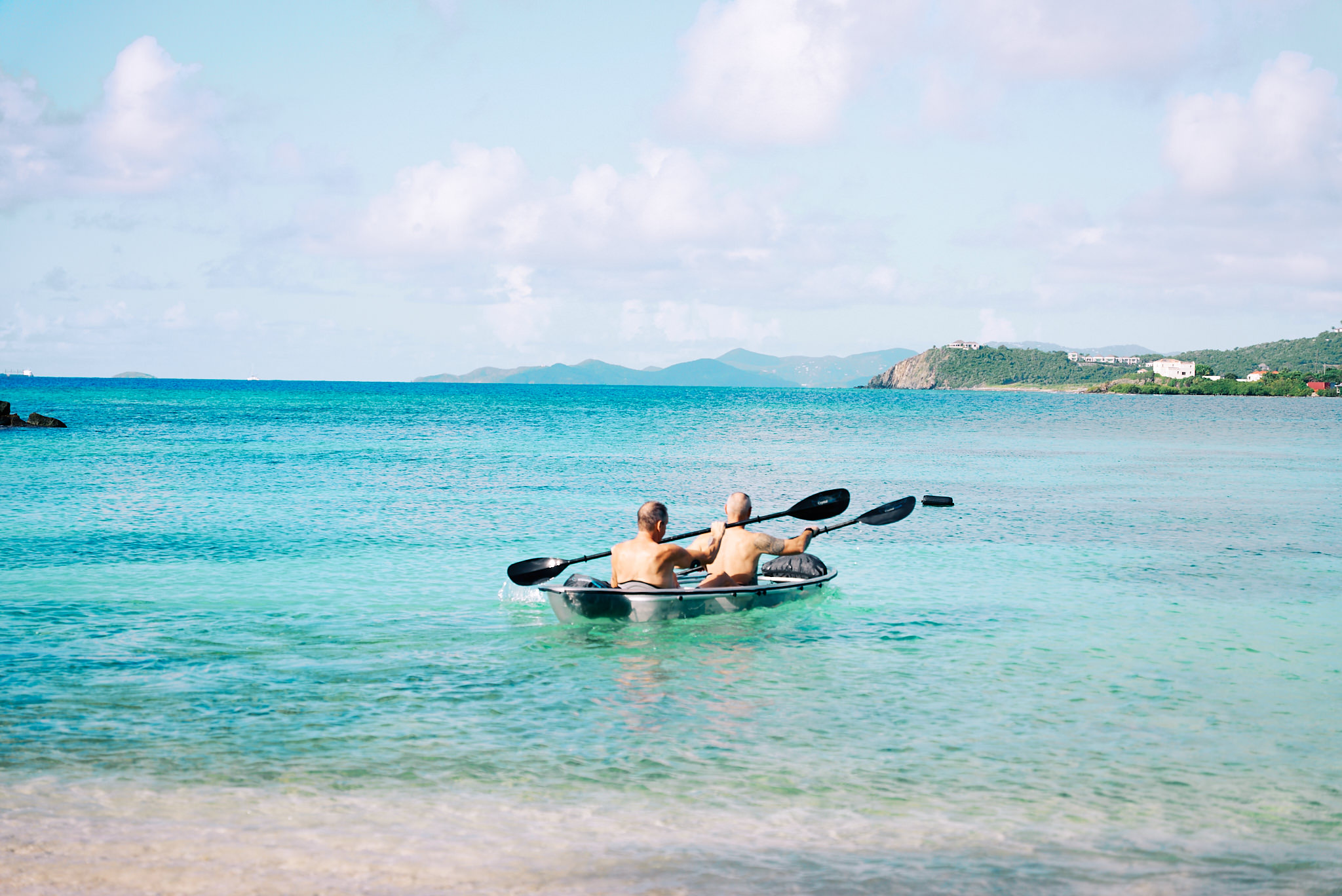 Guests kayaking in crystal clear water at The Aerial BVI