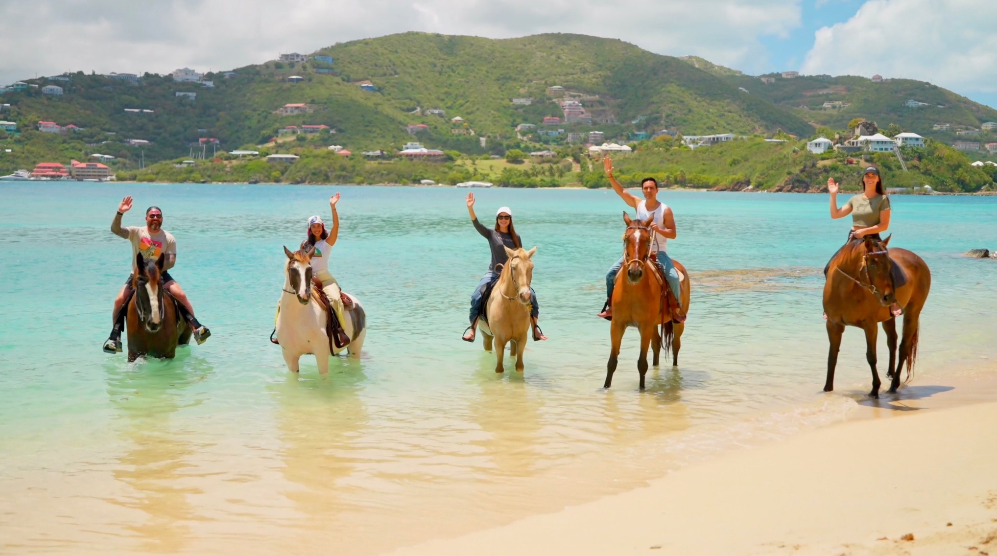 Guests on horseback in the shallows at Redemption Ranch, The Aerial BVI