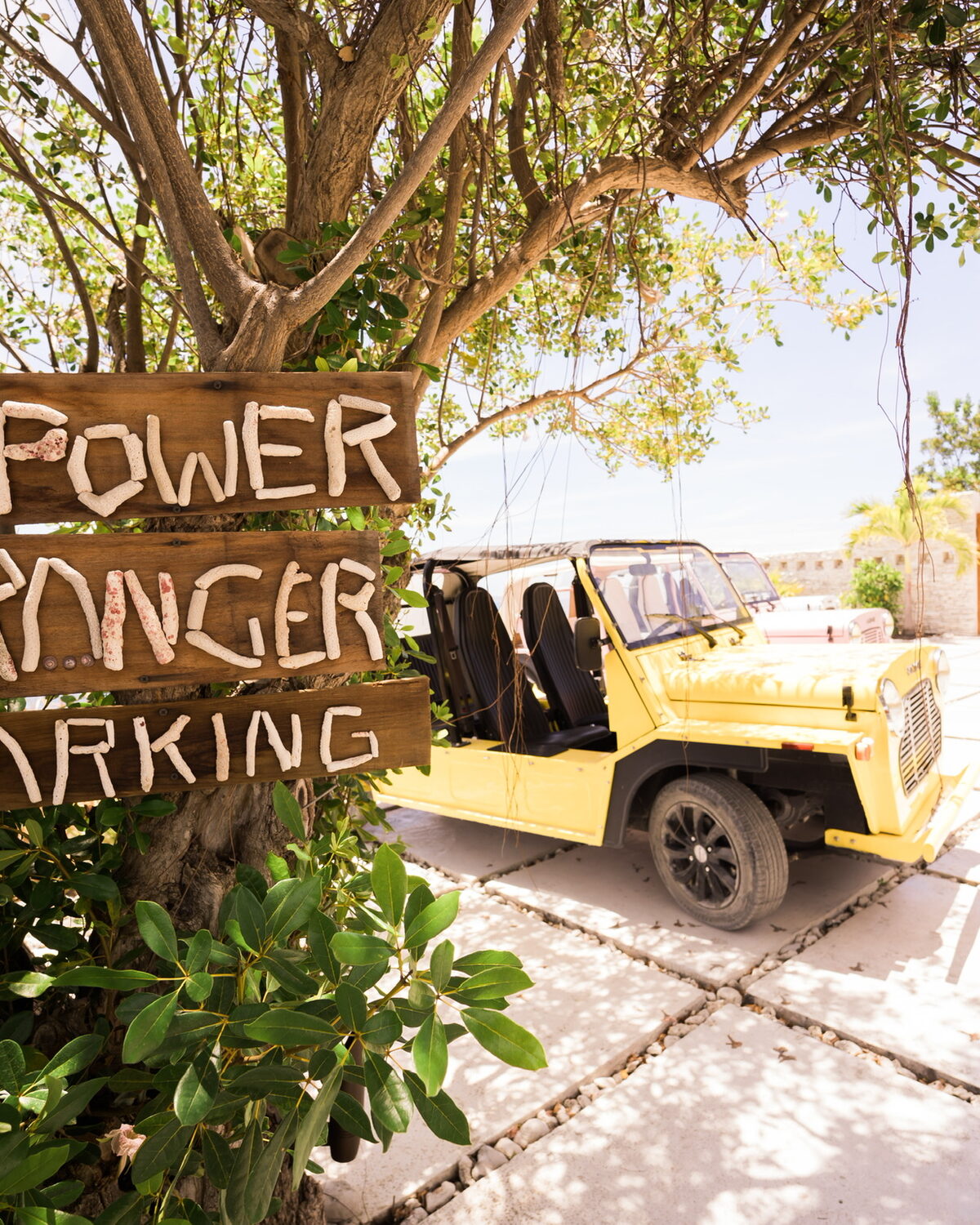 Island vehicle waiting beneath a coral-stone Power Ranger Parking sign