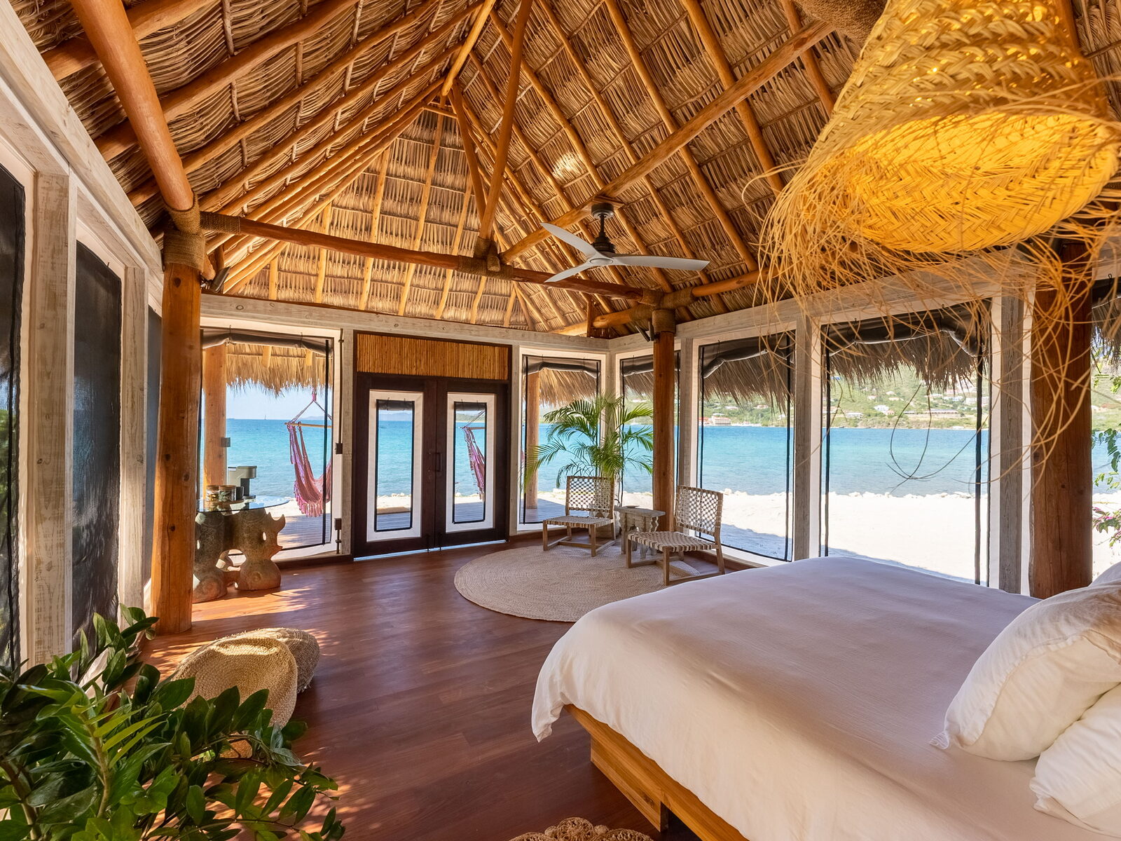 Mindfulness — thatched-roof beachfront cabana with floor-to-ceiling ocean views